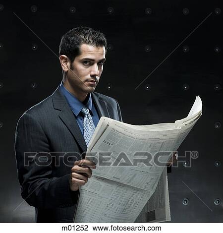 businessman holding a newspaper View Large Photo Image Stock Image - businessman holding a newspaper. Fotosearch