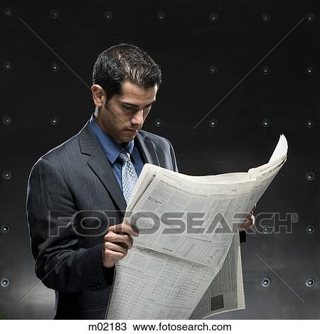 Stock Image - businessman holding a newspaper. Fotosearch