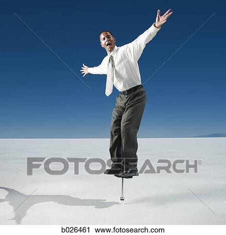 Stock Image - businessman on a pogo stick. Fotosearch