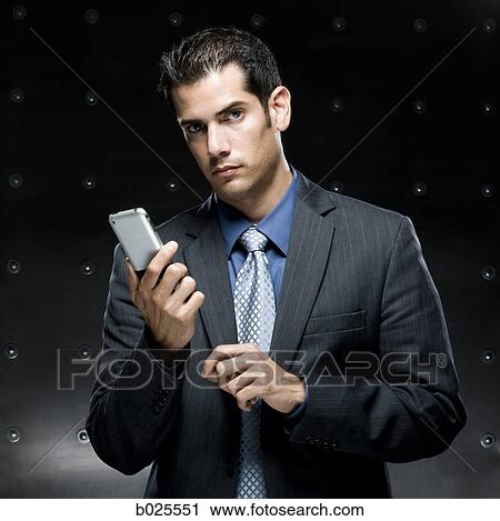 Stock Image - businessman using a cell phone. Fotosearch