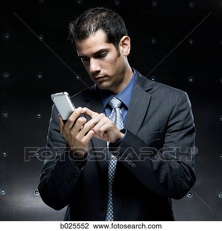 Stock Image - businessman using a cell phone. Fotosearch