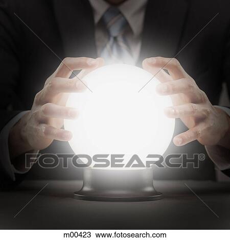 Stock Image - businessman with crystal ball. Fotosearch