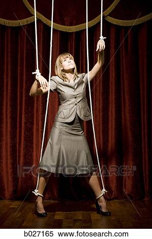 businesswoman being pulled by strings like a puppet View Large Photo Image Stock Photography - businesswoman being pulled by strings like a puppet. Fotosearch