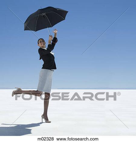 businesswoman holding an umbrella in the desert View Large Photo Image Stock Photo - businesswoman holding an umbrella in the desert. Fotosearch
