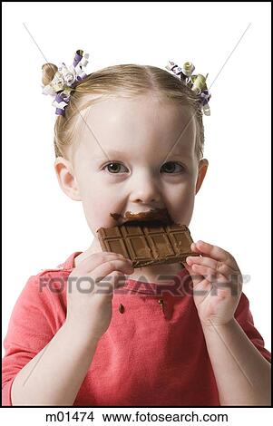 Picture - child eating chocolate. Fotosearch