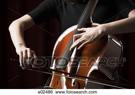 Close-up of young woman playing cello View Large Photo Image Stock Photograph - Close-up of young woman playing cello. Fotosearch