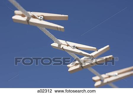 Clothes pegs hanging on washing line View Large Photo Image Stock Image - Clothes pegs hanging on washing line. Fotosearch