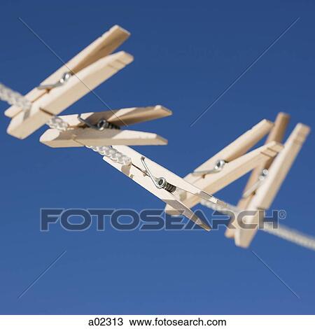 Clothes pegs hanging on washing line View Large Photo Image Stock Image - Clothes pegs hanging on washing line. Fotosearch