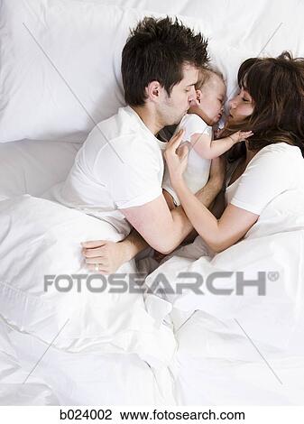 couple and baby in bed View Large Photo Image Stock Image - couple and baby in bed. Fotosearch