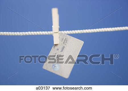 Credit card hanging on clothes line View Large Photo Image Stock Photo - Credit card hanging on clothes line. Fotosearch