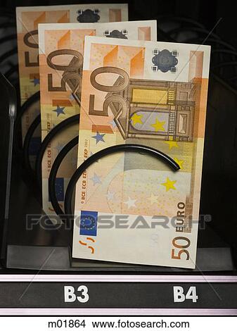Picture - currency in a vending machine. Fotosearch
