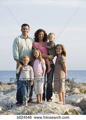 Stock Photograph - family at the beach. Fotosearch