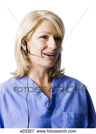 Female nurse using headset, studio shot View Large Photo Image Stock Photo - Female nurse using headset, studio shot. Fotosearch
