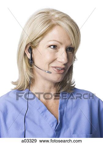 Female nurse using headset, studio shot View Large Photo Image Stock Photo - Female nurse using headset, studio shot. Fotosearch