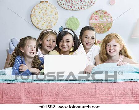five girls on a bed with a sign View Large Photo Image Stock Image - five girls on a bed with a sign. Fotosearch