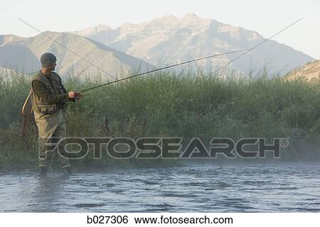 fly fisherman fishing in a mountain river View Large Photo Image Stock Photograph - fly fisherman fishing in a mountain river. Fotosearch