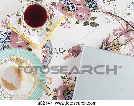 Food and drink with glasses and laptop on floral tablecloth View Large Photo Image Stock Photo - Food and drink with glasses and laptop on floral tablecloth. Fotosearch