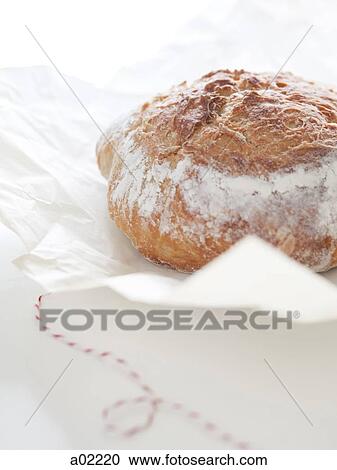 Fresh bread on wrapping paper, close-up View Large Photo Image Stock Image - Fresh bread on wrapping paper, close-up. Fotosearch