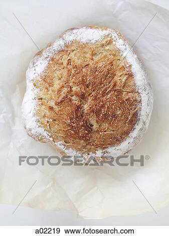 Stock Photo - Fresh bread on wrapping paper, view from above. Fotosearch