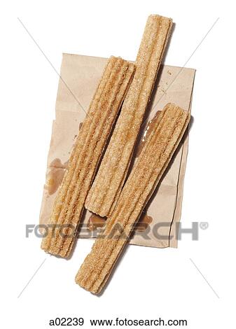 Stock Photo - Fresh stick shaped cakes on paper bag, view from above, studio shot. Fotosearch