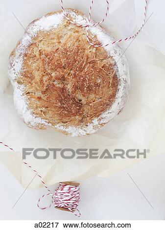 Freshly baked bread and spool of string on wrapping paper, view from above View Large Photo Image Stock Photo - Freshly baked bread and spool of string on wrapping paper, view from above. Fotosearch