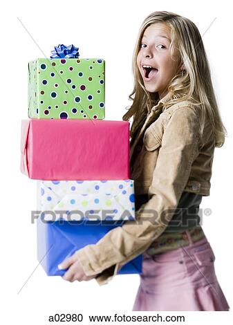 Girl (10--11) holding a stack of presents, portrait View Large Photo Image Stock Image - Girl (10--11) holding a stack of presents, portrait. Fotosearch
