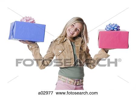 Girl (10--11) standing with gifts, portrait View Large Photo Image Stock Photo - Girl (10--11) standing with gifts, portrait. Fotosearch