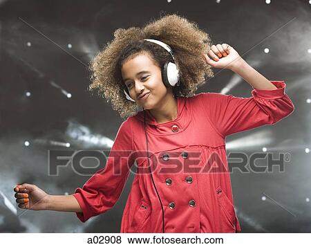 Girl (12-13) dancing with headphones View Large Photo Image Stock Photo - Girl (12-13) dancing with headphones. Fotosearch