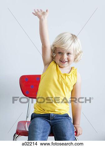 Girl (2-3) girl sitting on chair and raising hand, studio shot View Large Photo Image Picture - Girl (2-3) girl sitting on chair and raising hand, studio shot. Fotosearch