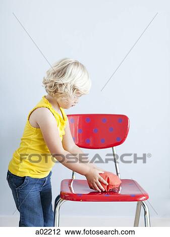 Girl (2-3) putting whoopie cushion on chair, studio shot View Large Photo Image Stock Image - Girl (2-3) putting whoopie cushion on chair, studio shot. Fotosearch