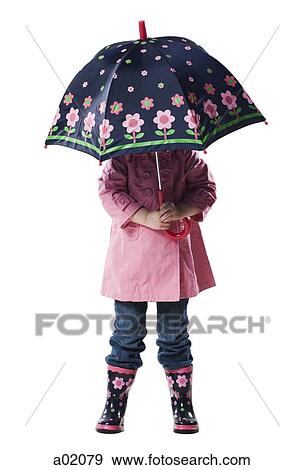 Stock Photo - Girl (2-3 years) holding umbrella over head, studio shot. Fotosearch