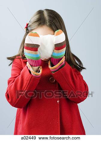 Girl (6-7) in red coat holding fresh snow ball View Large Photo Image Stock Photo - Girl (6-7) in red coat holding fresh snow ball. Fotosearch