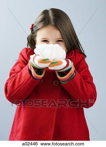 Girl (6-7) in red coat holding fresh snow View Large Photo Image Stock Photograph - Girl (6-7) in red coat holding fresh snow. Fotosearch