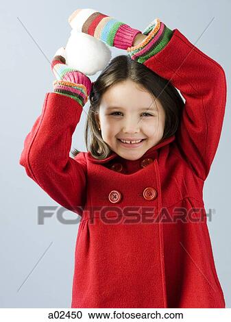 Girl (6-7) in red coat holding snow ball View Large Photo Image Stock Image - Girl (6-7) in red coat holding snow ball. Fotosearch