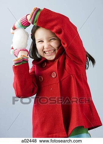 Girl (6-7) in red coat holding snow ball View Large Photo Image Stock Photo - Girl (6-7) in red coat holding snow ball. Fotosearch