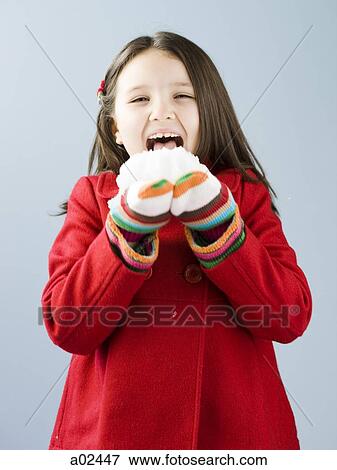Girl (6-7) in red coat licking fresh snow View Large Photo Image Stock Photo - Girl (6-7) in red coat licking fresh snow. Fotosearch
