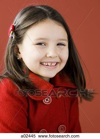 Stock Photography - Girl (6-7) in red coat smiling, portrait. Fotosearch