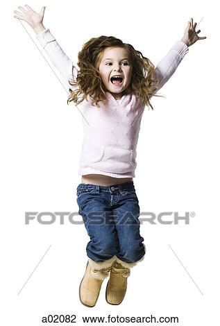 Stock Image - Girl (6-7) jumping against white background. Fotosearch