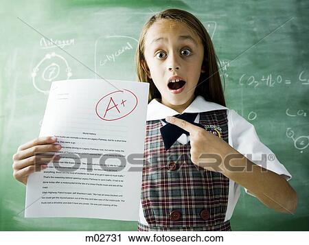 girl in a classroom standing in front of a chalkboard with an a plus paper View Large Photo Image Stock Image - girl in a classroom standing in front of a chalkboard with an a plus paper. Fotosearch