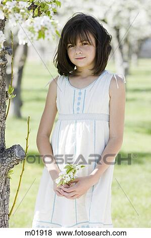 Stock Photo - girl in an orchard. Fotosearch