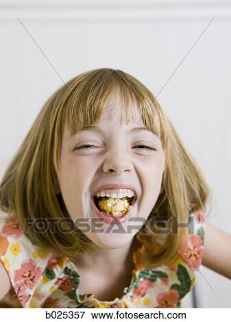 girl laughing with a mouth full of food View Large Photo Image Stock Photo - girl laughing with a mouth full of food. Fotosearch