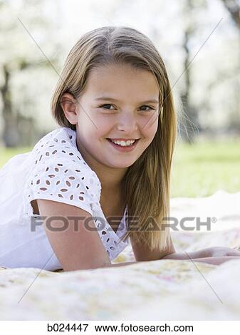 Stock Photo - girl lying on a blanket. Fotosearch
