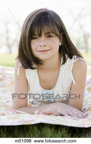 girl lying on a blanket View Large Photo Image Stock Photo - girl lying on a blanket. Fotosearch