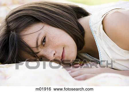 girl lying on a blanket View Large Photo Image Stock Photograph - girl lying on a blanket. Fotosearch