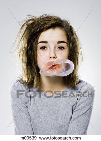 girl with a messy appearance popping a bubble gum bubble View Large Photo Image Stock Photo - girl with a messy appearance popping a bubble gum bubble. Fotosearch