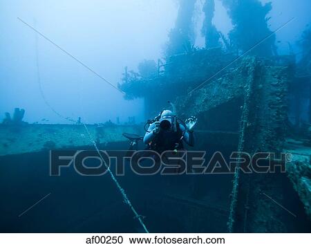 Stock Image - Grenada, Caribbean Sea, Scuba diver next to shipwreck. Fotosearch