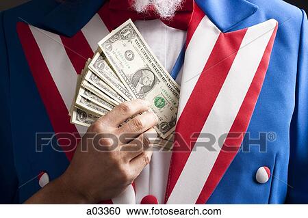 Hand hiding banknotes under vest, studio shot View Large Photo Image Stock Image - Hand hiding banknotes under vest, studio shot. Fotosearch