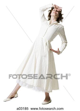 Stock Photography - Happy young woman dancing, studio shot. Fotosearch