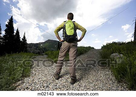hiker choosing which path to take View Large Photo Image Stock Image - hiker choosing which path to take. Fotosearch