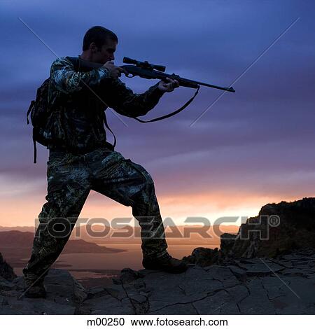 Stock Image - hunter against a sunset. Fotosearch